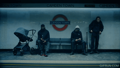 Three People Sit On A Bench At Camden Town Subway Station GIF