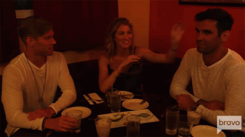 Three People Sitting at Table with Bravo