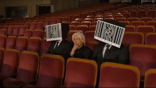 Three People With Barcodes on Face in Auditorium