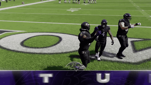 Three Ravens Players Standing on Football Field