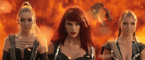 Three Red-Haired Women Standing in Front of Fire