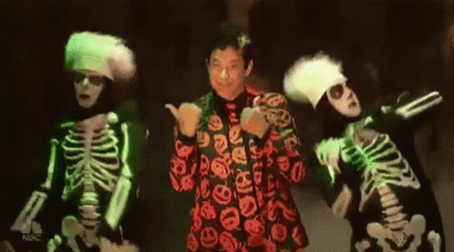 Three Skeletons Are Dancing In Front Of A Man In A Red Suit GIF