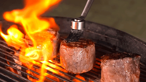 Three Steaks On Grill With Brush GIF