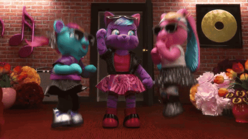 three stuffed animals are dancing in front of a record