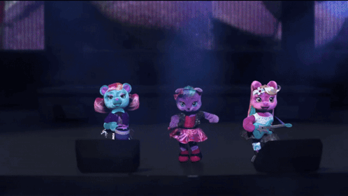 three stuffed animals are dancing on a stage and one has a microphone in her hand