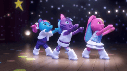three stuffed animals are dancing on a stage