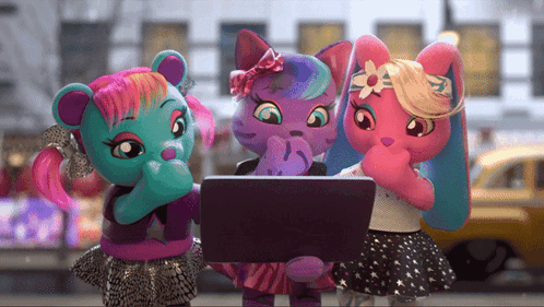 three stuffed animals looking at a laptop together