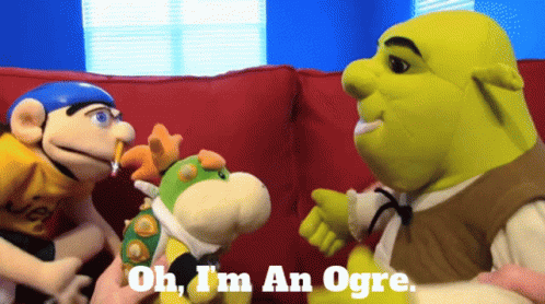 Three Stuffed Animals on Red Couch Including Shrek