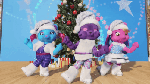 three stuffed animals wearing santa hats are standing in front of a christmas tree