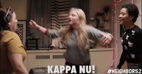 Three Women Are Dancing In A Room And One Of Them Is Saying Kappa Nu ! GIF