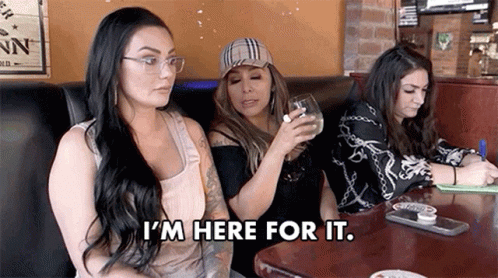 Three Women Are Sitting At A Table In A Restaurant . GIF