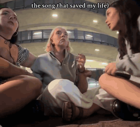 Three Women Are Sitting On The Ground With The Words The Song That Saved My Life Written Above Them GIF