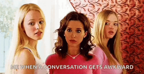 Three Women Are Standing Next To Each Other And One Of Them Is Wearing A Pink Sweater . GIF