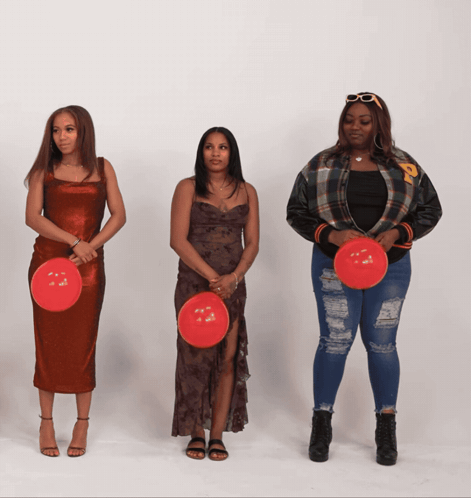 Three Women Are Standing Next To Each Other Holding Red Balloons With The Letter P On Them GIF