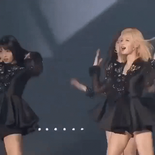 Three Women Are Standing Next To Each Other On A Stage In Black Dresses . GIF