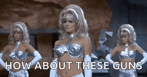 Three Women Are Standing Next To Each Other With Their Hands On Their Hips And The Words `` How About These Guns '' Abov GIF