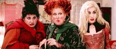Three Women Dressed as Witches Standing Together