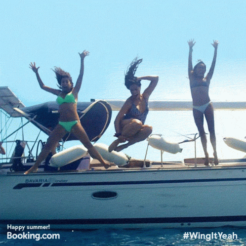 Three Women In Bikinis Jumping Off A Boat That Says Bavaria On It GIF