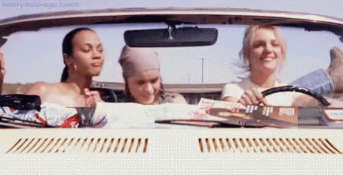 Three Women in Convertible Looking at Map