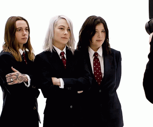 Three Women in Suits With Arms Crossed
