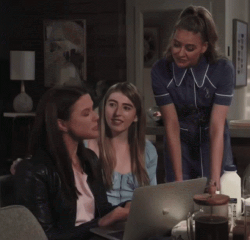 Three Women Looking At Laptop One In Nurse Uniform GIF