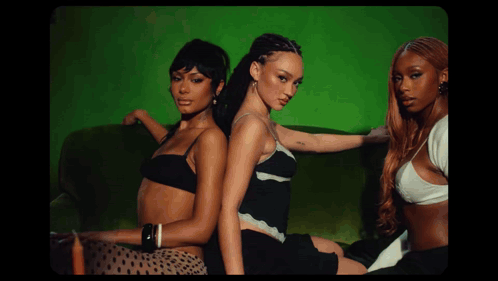 Three Women Posing on Green Background