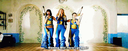 Three Women Singing In A Room With The Words Mamma Mia Here I Go Again Above Them GIF