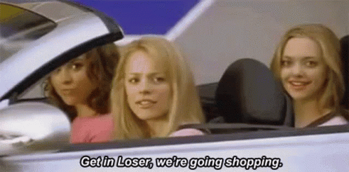 Three Women Sitting in Car One Talking About Shopping