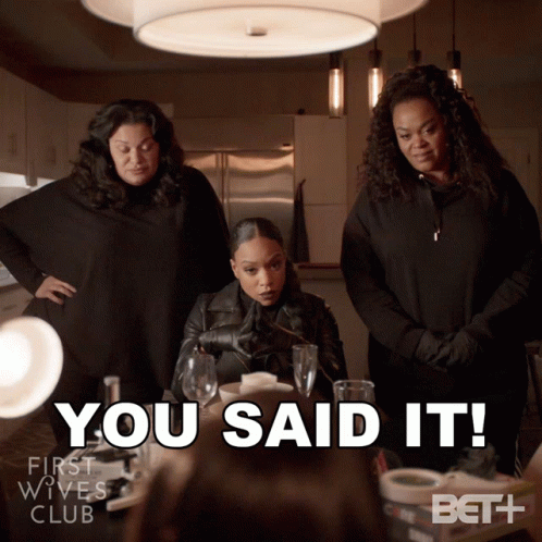 Three Women Standing Around A Table With The Words You Said It GIF