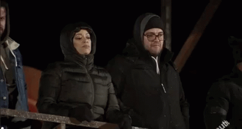 Three Women Standing In Dark Room GIF