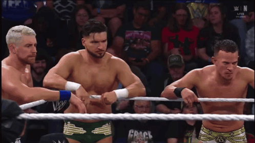 Three Wrestlers In Ring With Crack Rope GIF