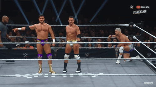 Three Wrestlers In Ring With YouTube Logo GIF