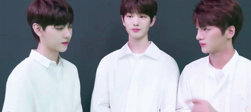 three young men wearing white shirts are standing next to each other