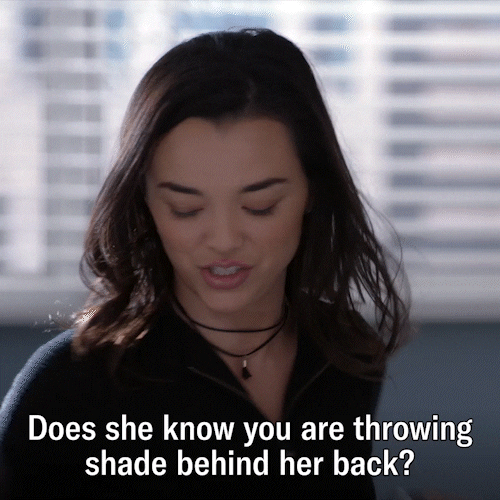 Throwing Shady Behind Her Back GIF