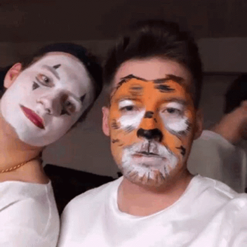 Tiger Face Man Next to Clown Face Man