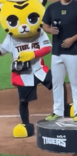 Tiger Mascot on Podium with Man Behind
