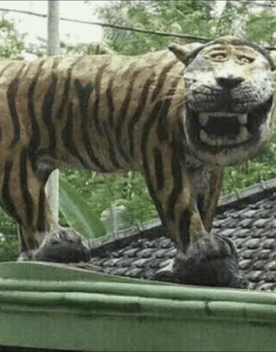 Tiger Statue On Green Gutter GIF