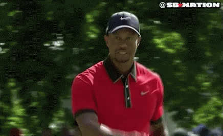Tiger Woods Wearing Red Shirt and Black Hat