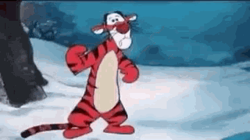 tigger from winnie the pooh is standing in the snow and looking at the camera .