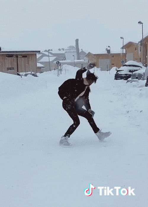 Tiktok guy loses balance in snow gif.