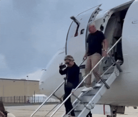 Tim Walz Going Down The Airplane GIF