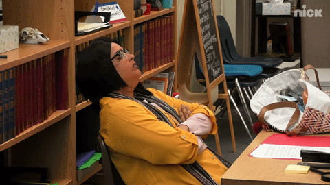 Tired Teacher Leaning On Bookshelf GIF
