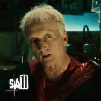Tobin Bell Smiling In Saw Movie GIF