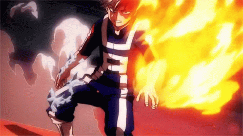 Todoroki Shouto From My Hero Academia Is Standing In Front Of A Wall With Fire Coming Out Of His Hand . GIF