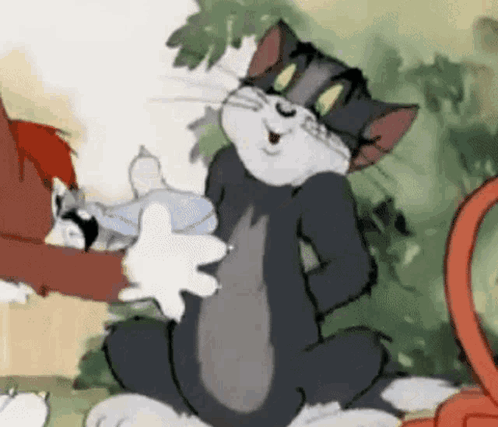 Tom And Jerry Are Sitting Next To Each Other In A Cartoon . Tom Is Holding A Fish In His Hand . GIF