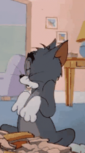 Tom Cat Grinning And Hiding Paws GIF