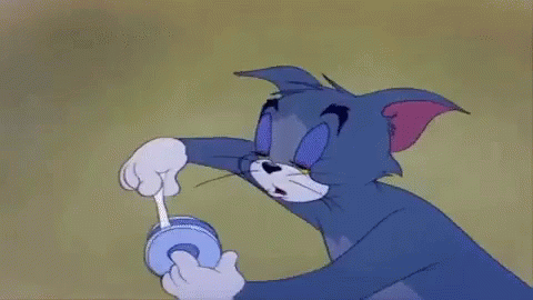 Tom From The Cartoon Tom And Jerry Is Playing With A Toy . GIF