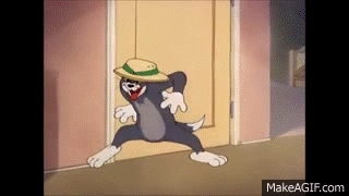 Tom From Tom And Jerry Is Wearing A Hat And Dancing In A Doorway . GIF