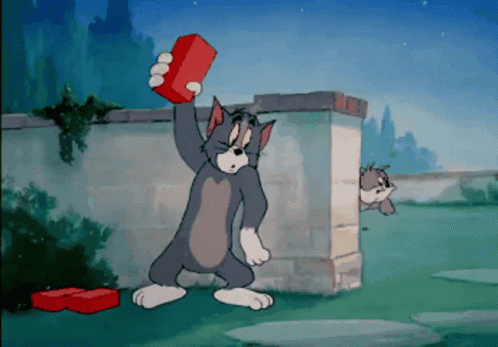Tom Holding Red Brick While Another Cat Looks On GIF