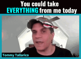 tommy tallarico is wearing a shark hat and talking to the camera
